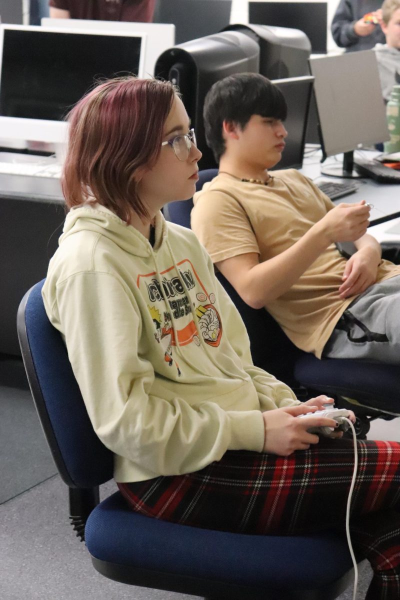 Sophomore Anna Maloney plays a video game.