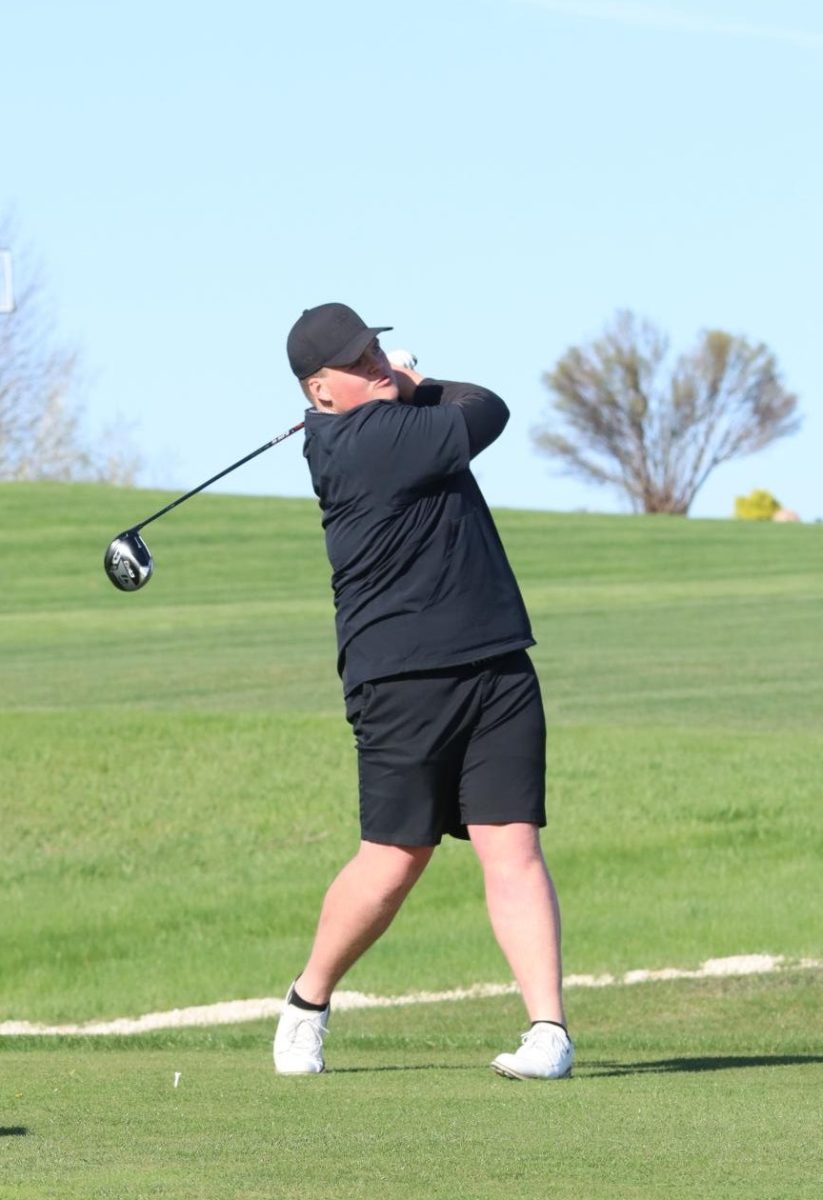 Macoy Peyton (12) hits the ball down the course.