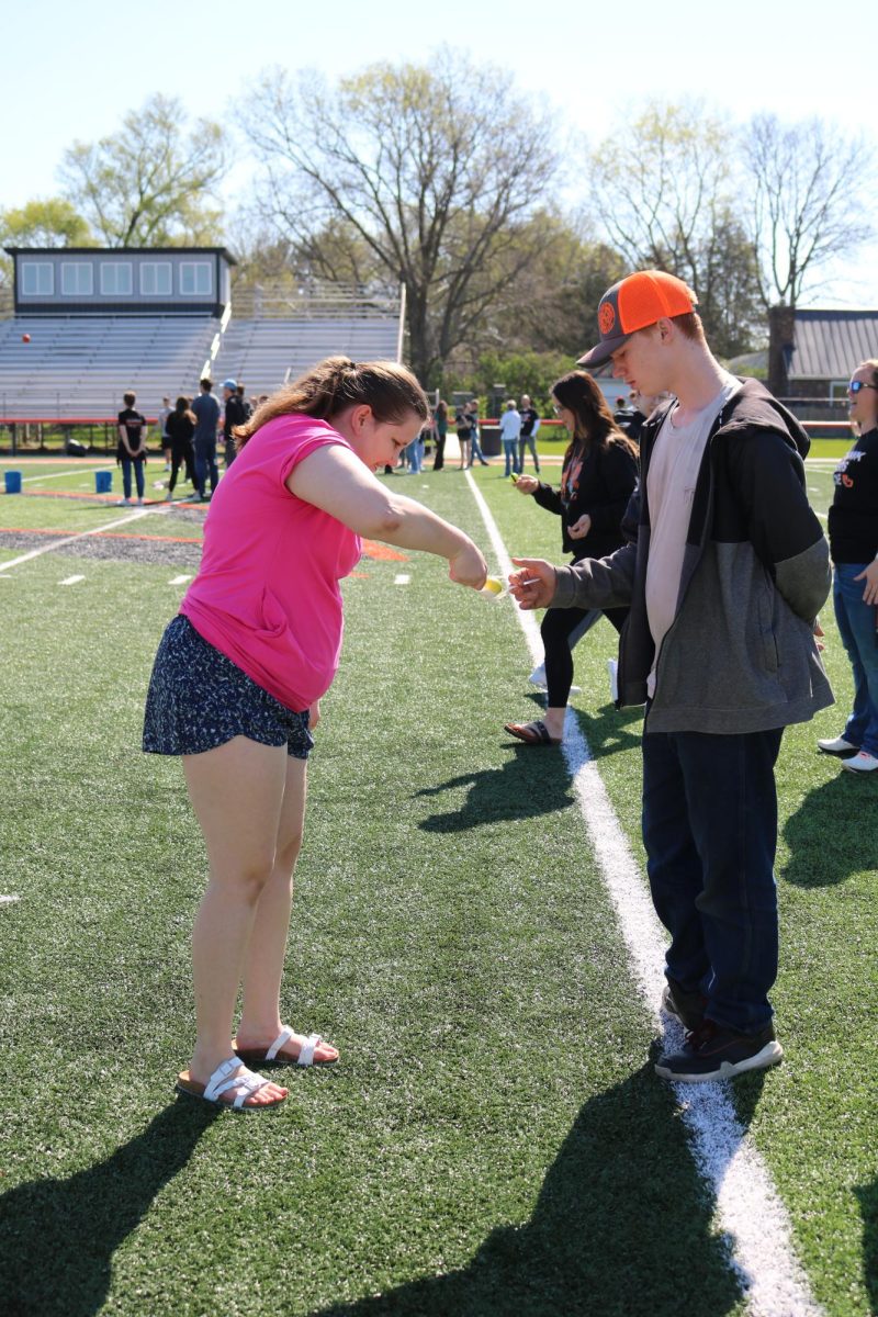 After Crossing the Ocean Kaylynn Goranson (11) passes the egg to Logan Bemer (11). Bemer raced  back across the ocean keeping the egg safe, winning the game.
