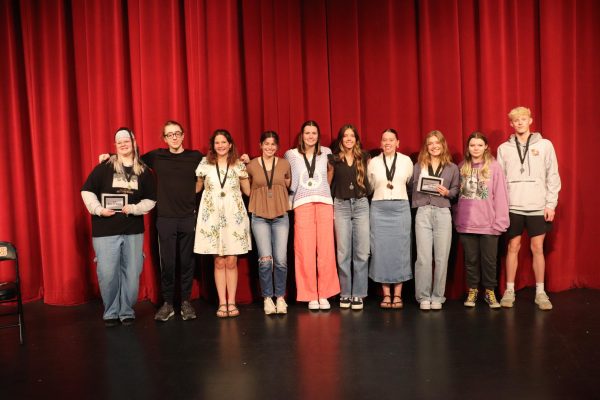 WaMaC Art Show participants Kira Roths (10), Jack Hutchinson (12), Sarah Perez (12), Kate Wenger (12), Hannah Cantwell (12), Emma Schmidt (11), Jaidyn Ronnebaum (12), Kennedy Loesche (12), Kayden Brady (12), and Caden Stickney (10) pose to show off their awards. 