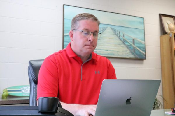 Typing at his computer, Principal Tim Felderman completes paperwork. Felderman has worked with students in all capacities from an Ag teacher to principal.