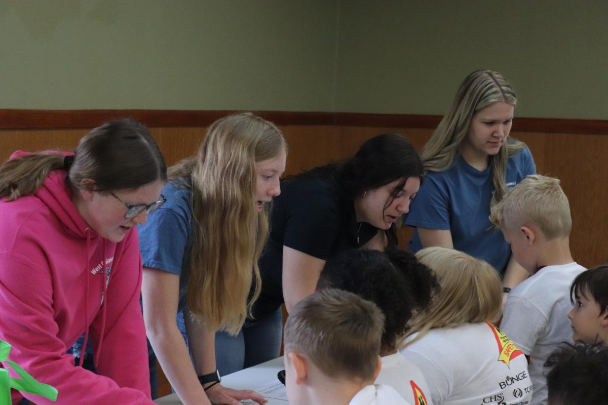 Teaching kids how to dial 911, Jayden Hillers (11), Isabelle Demmer (11), Karli Postel (11), and Cirra Cooksley (11) demonstrate the importance of knowing who to call in case of an emergency.