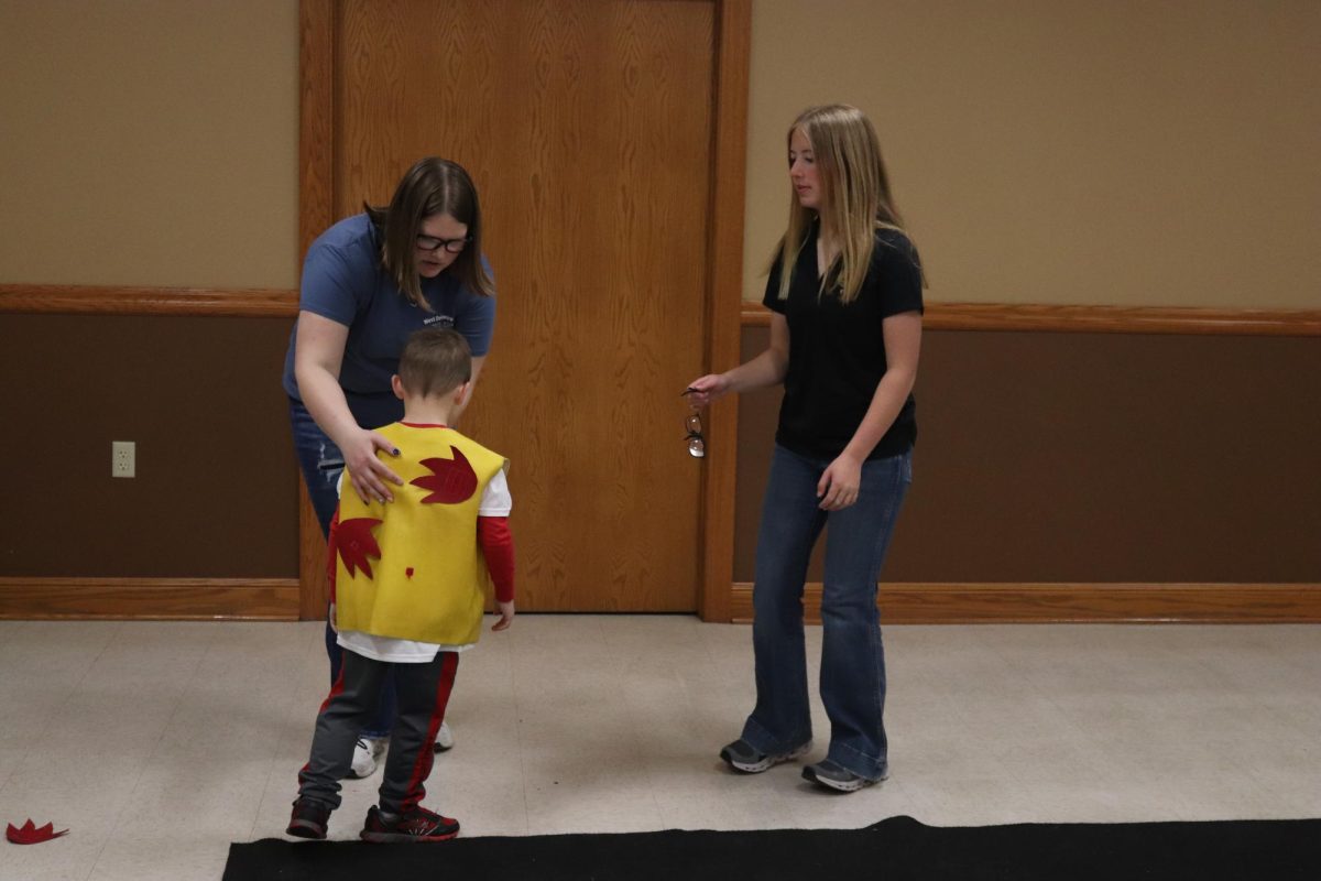 Josie Hillers (9) and Claire Smith (9) teach kids how to stop, drop, and roll. "It's important to educate kids on the dangers of living on a farm," Smith said.