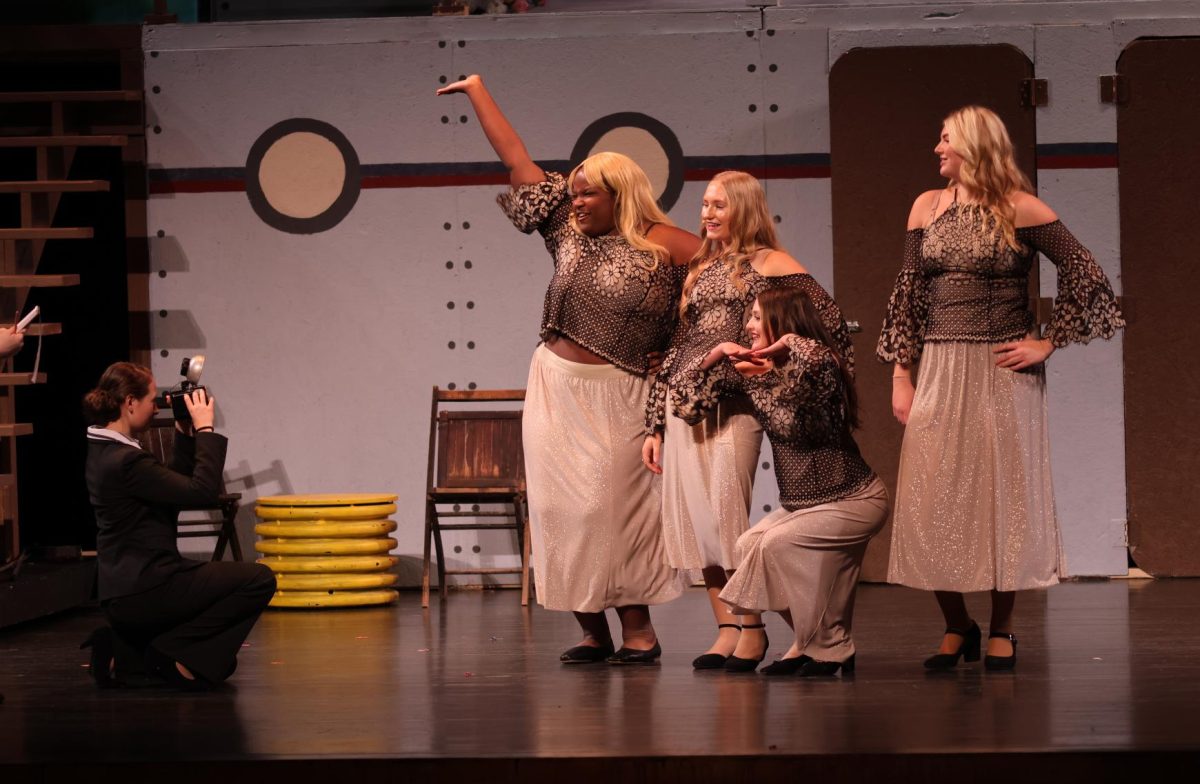 Addysin Kintzle (10) takes pictures of Tamara Pittman (10), Gwenyth Hough (10), Claire Hegland (9), and Maya Penningtion (12) durring the first act. 