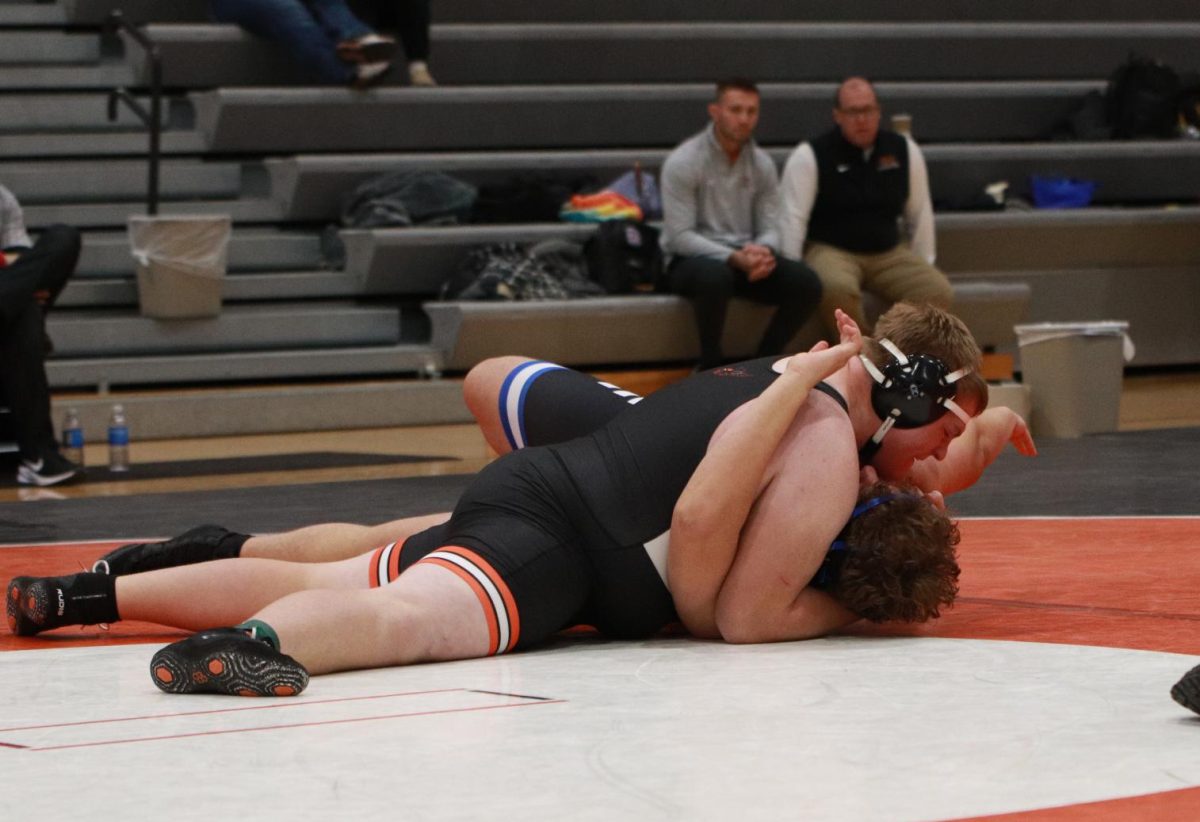 Jakob Jones-Hutchinson (9) delivers a 38-second pin in the third round of the Bob Murphy Tournament. Earlier, he battled to a 2–0 win in the opening round before advancing through a second-round bye.