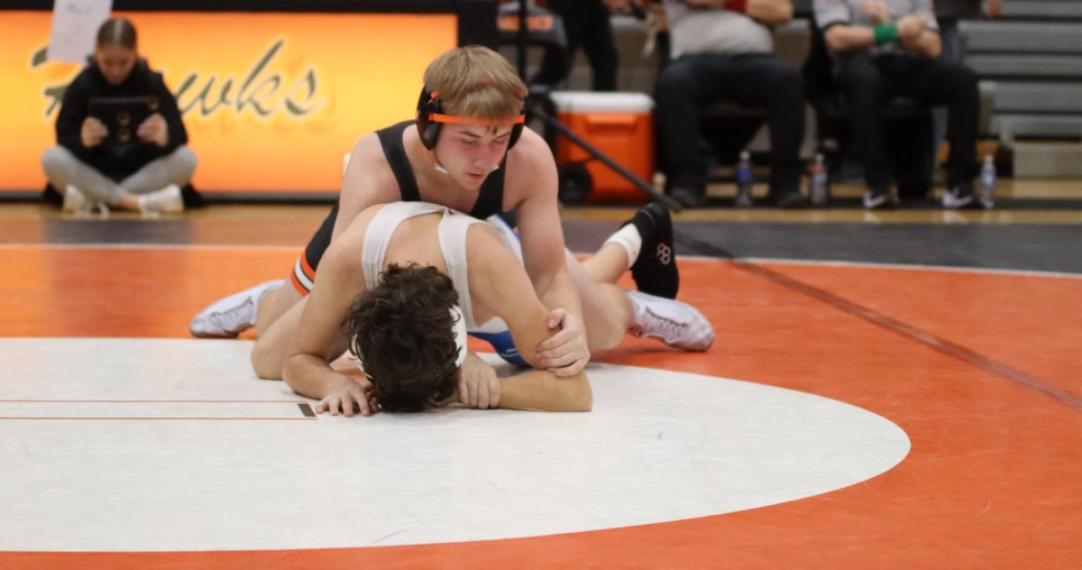 Aiden Wulfekuhle (12) gains advantage on the mat. He secured the pin in 50 seconds.
