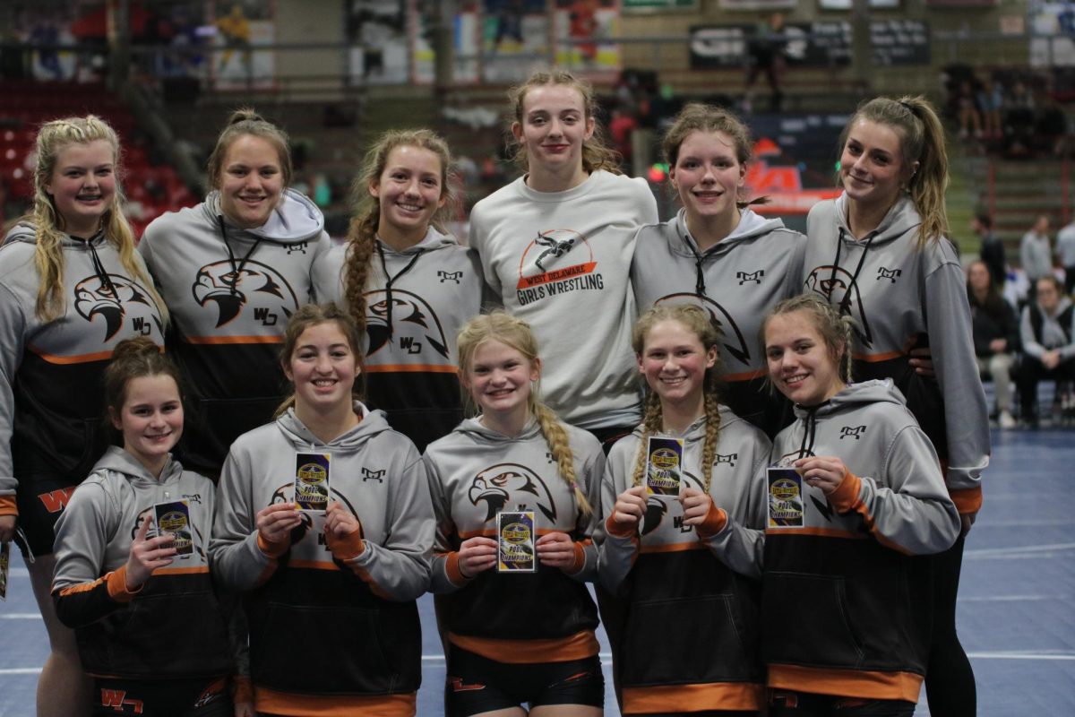 West Delaware Girls Wrestling team smiles for a group photo at the Battle of Waterloo