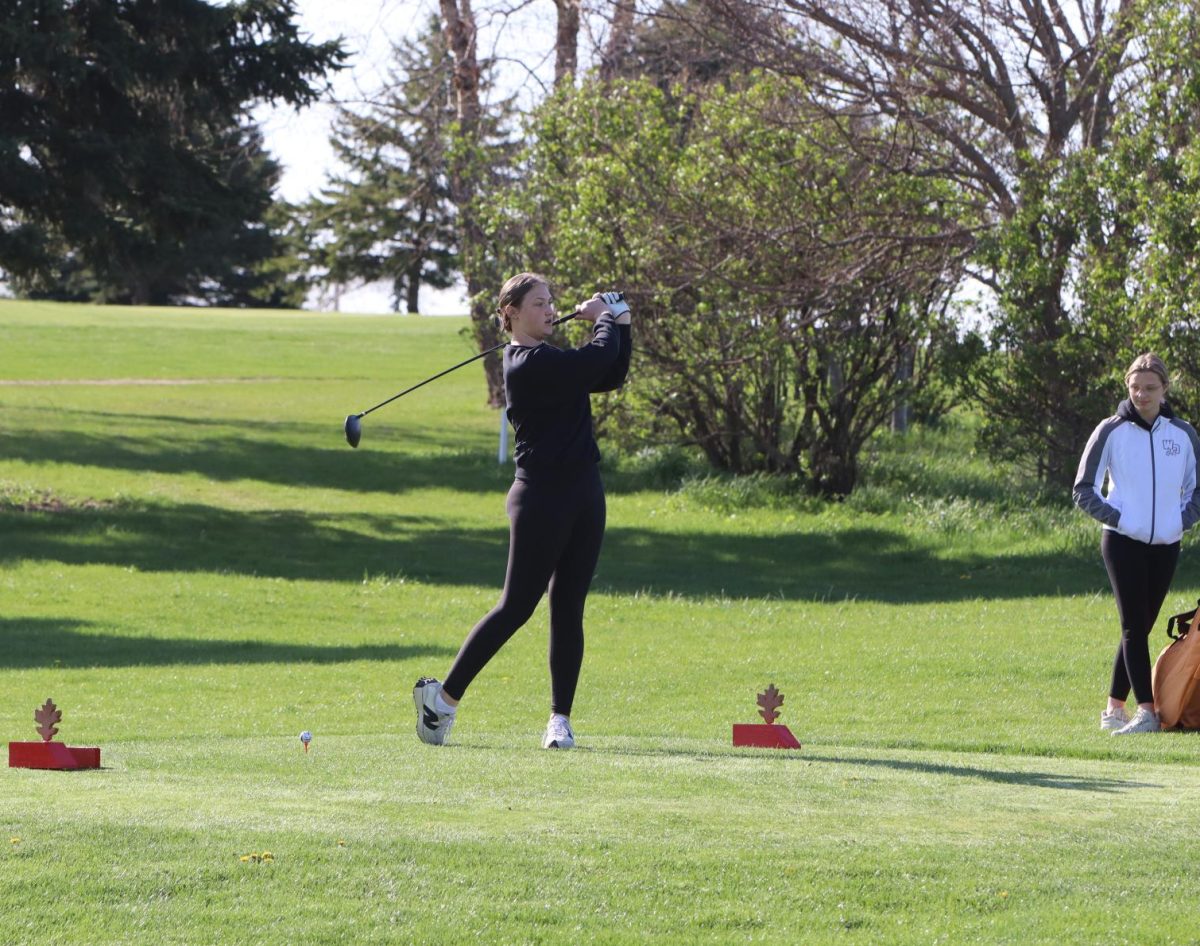 Practicing her swing, Addisyn Koontz (11) prepares to drive her ball.