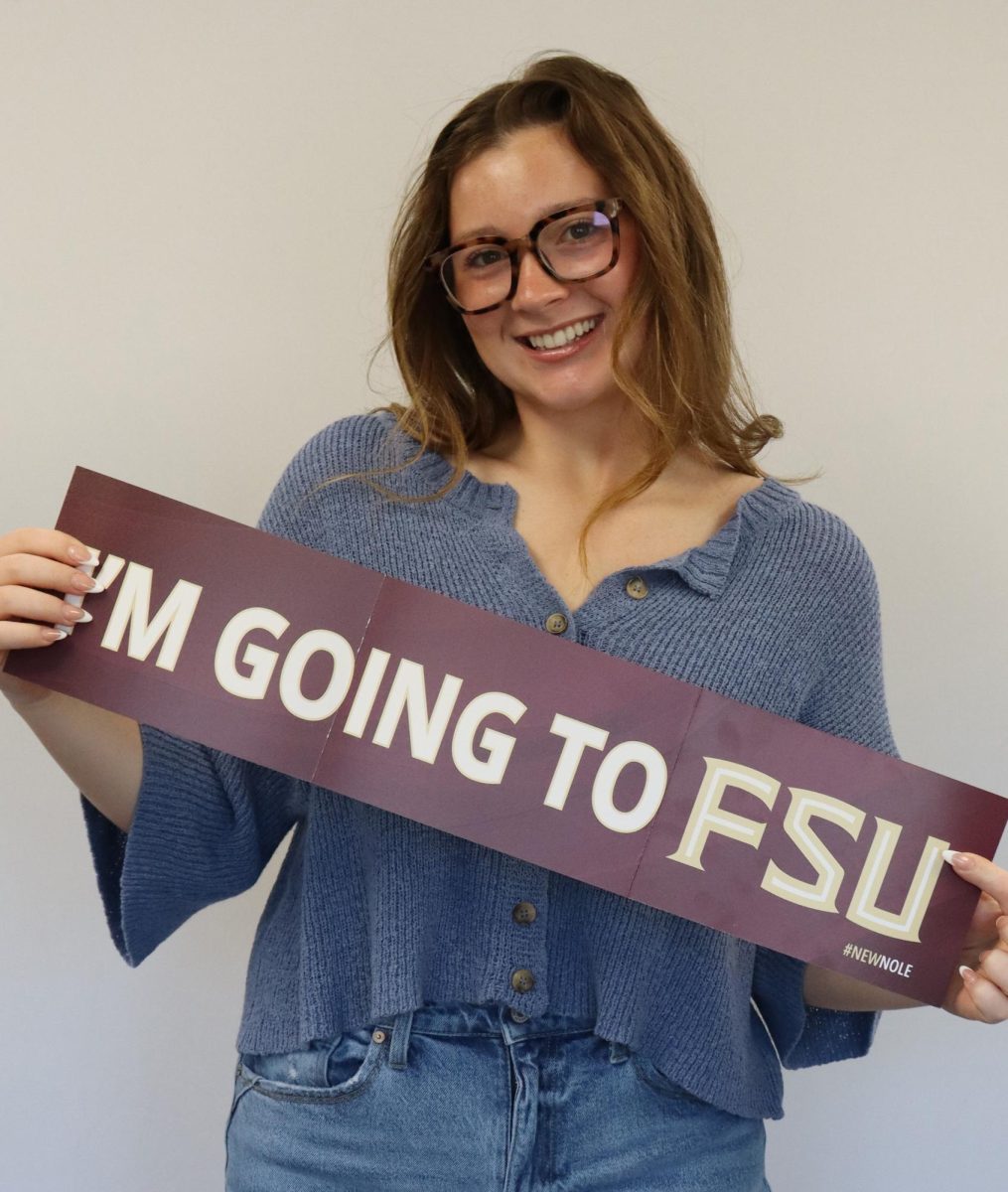 Grace Sleper (12) holds admission banner from Florida State University.