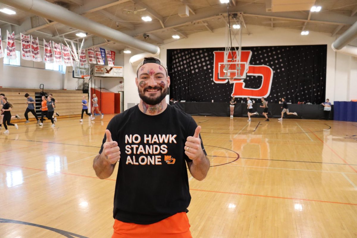 Teacher Matt Seabold shows off his face full of tattoos.