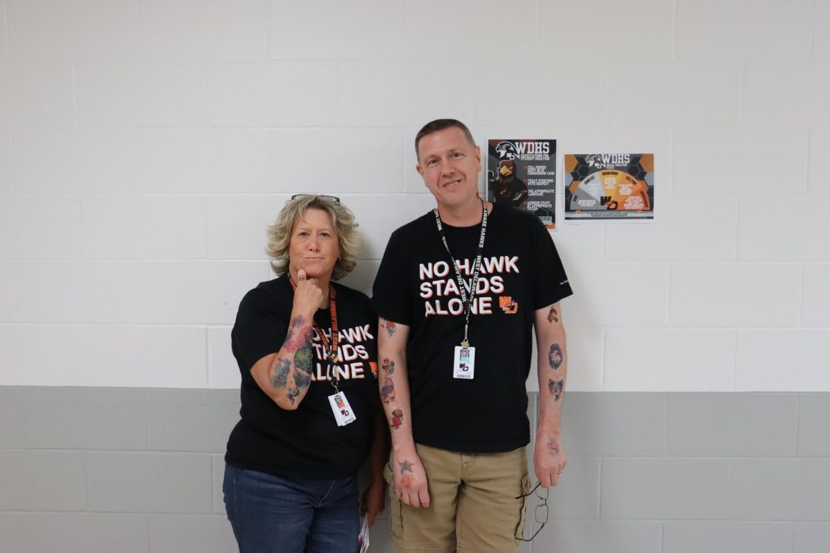 During tat the staff Friday, teachers Jennifer Huehnergarth and Dale Sperfslage show their tattoos.