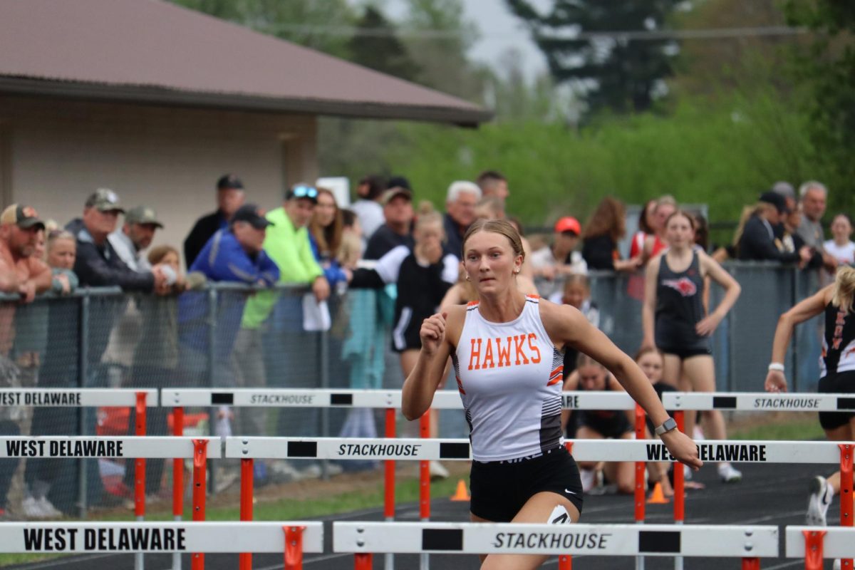 Avery Schmitz (11) competes in shuttle hurdle relay.